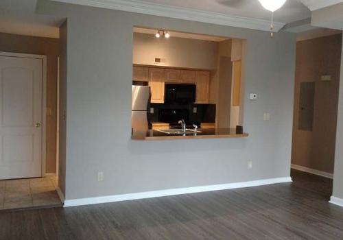 Living room with a view of the kitchen at The Gateway Towers at Packer Park apartments for rent