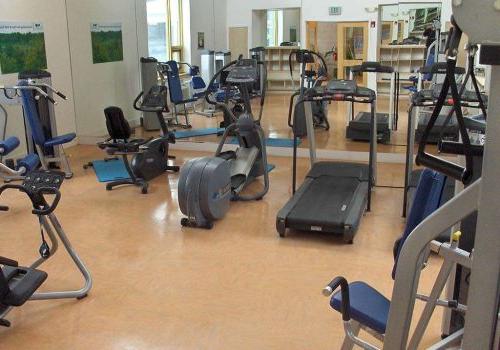 Fitness center with exercise equipment at The Gateway Towers at Packer Park apartments for rent